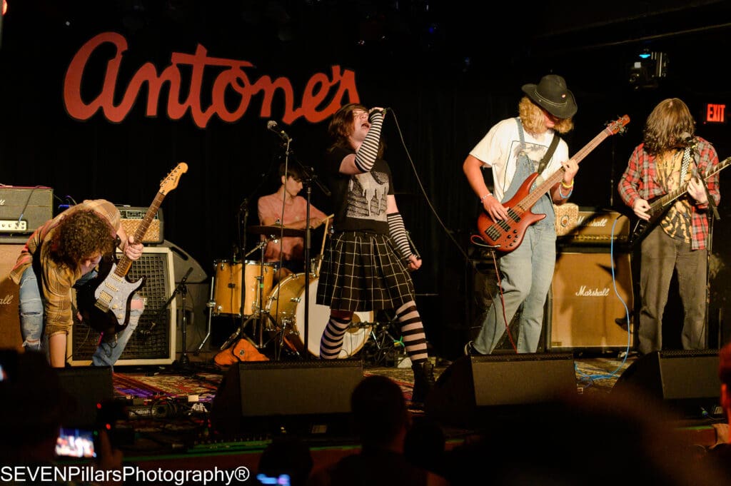 a band performing on stage in front of a crowd