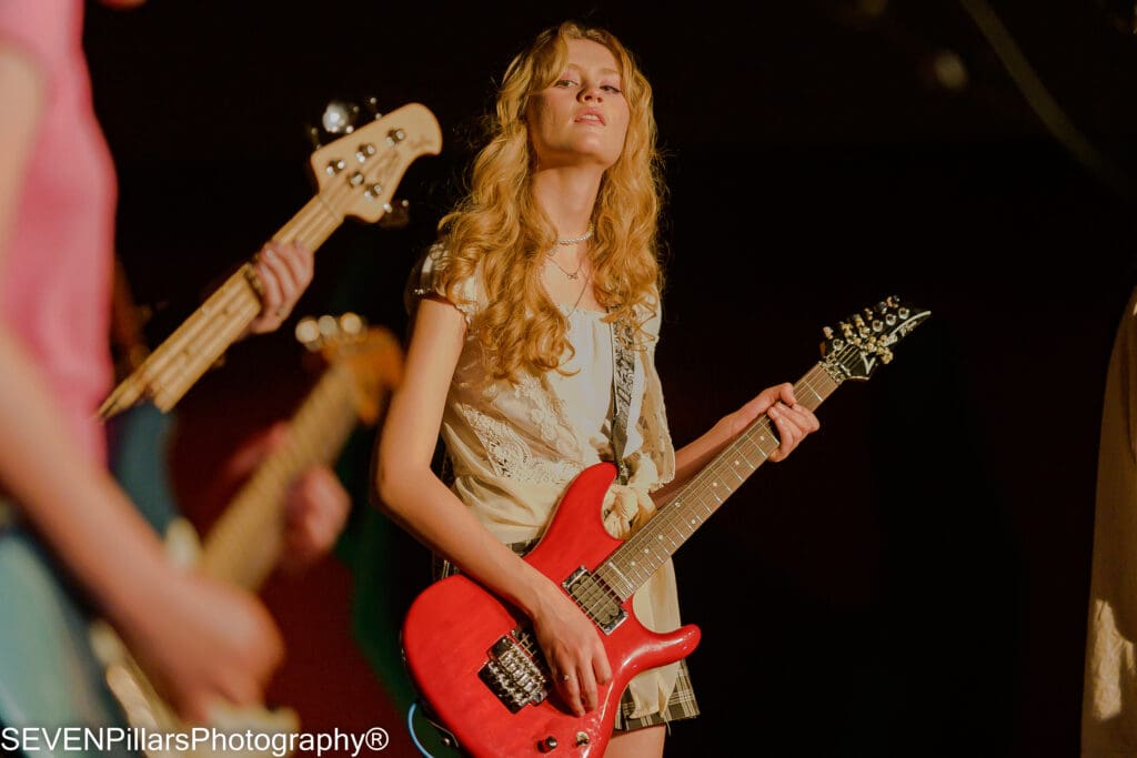 a teenage girl playing the guitar