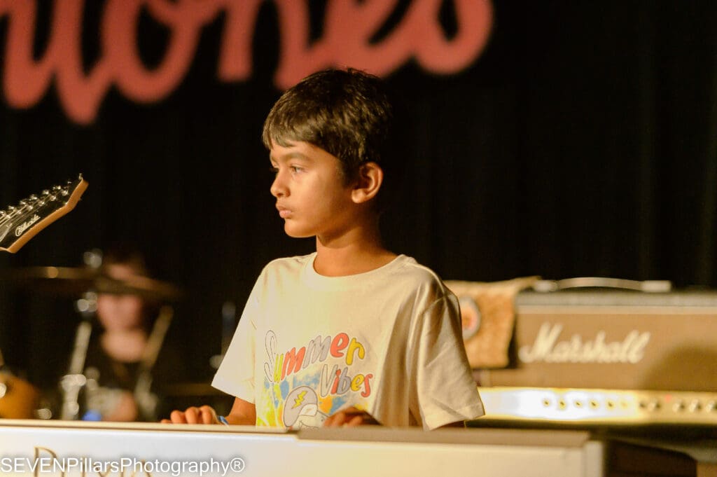 a young keyboardist looking at the audience