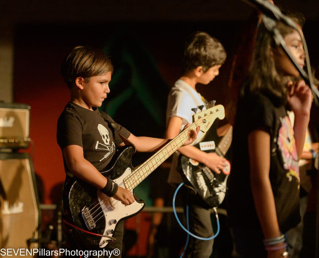 a young bassist looking at the audience