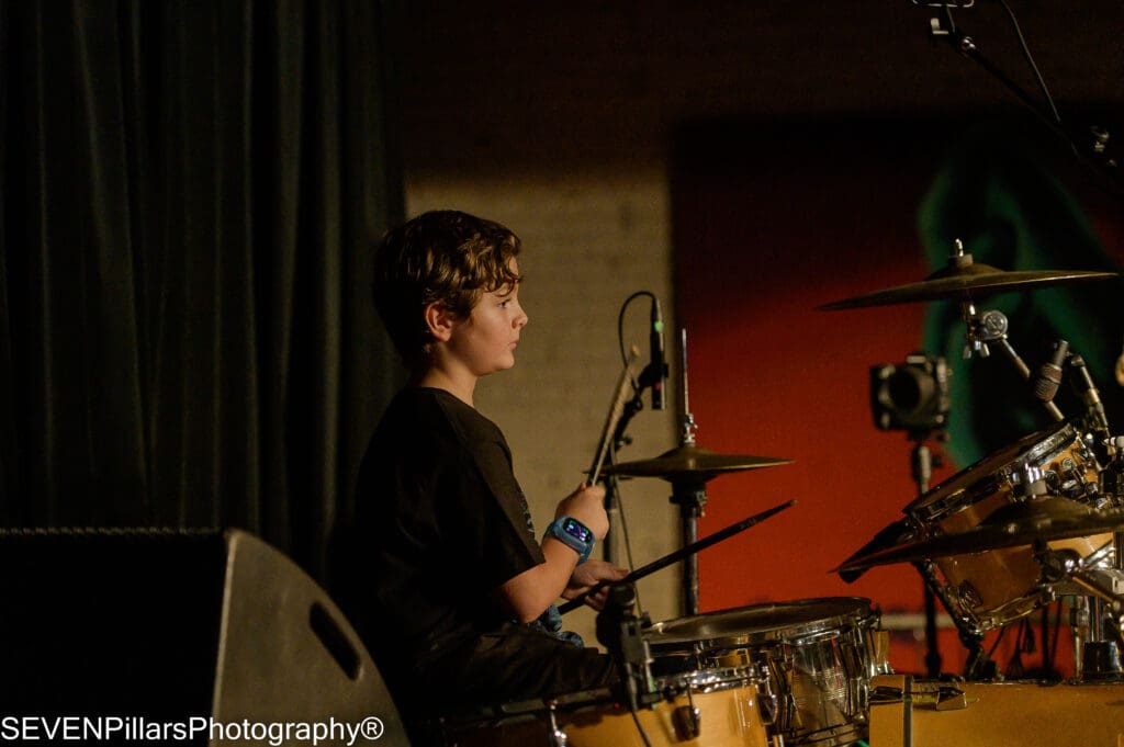 a young drummer looking at the audience