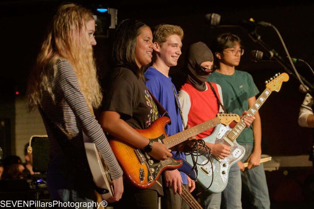 teenage performers smiling at the audience