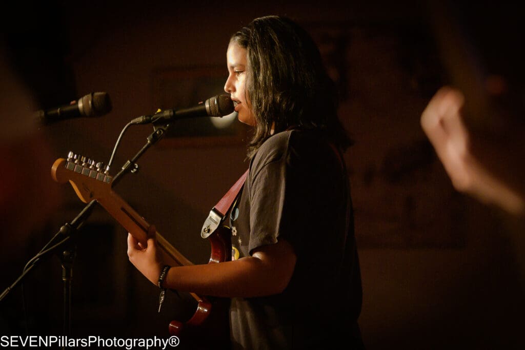 a bass player singing to the microphone