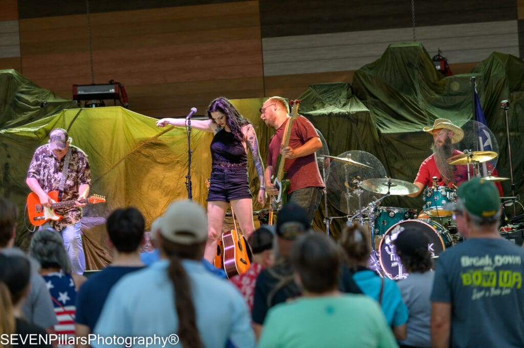 Lexxi Garza pointing her finger at her bassist