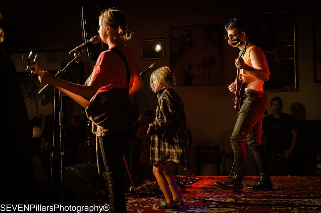 a band performing in front of a crowd at a nightclub