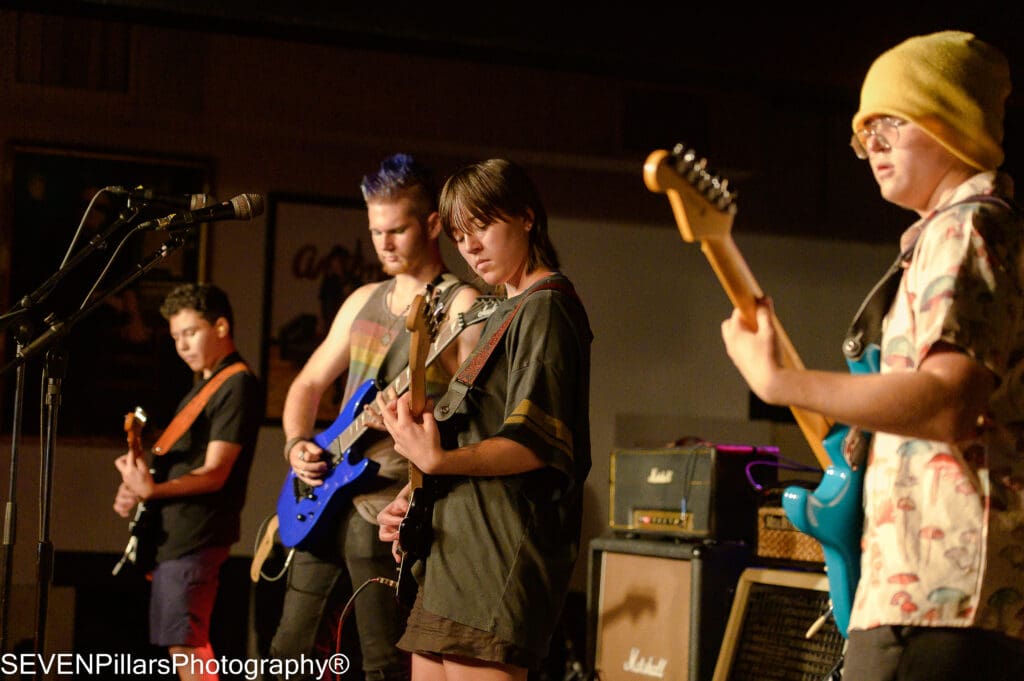 a four-member band performing on stage