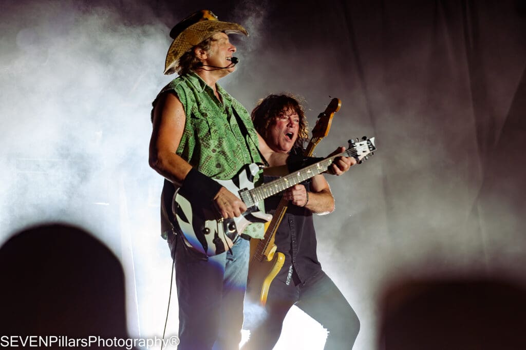 Ted Nugent performing with a fellow bassist