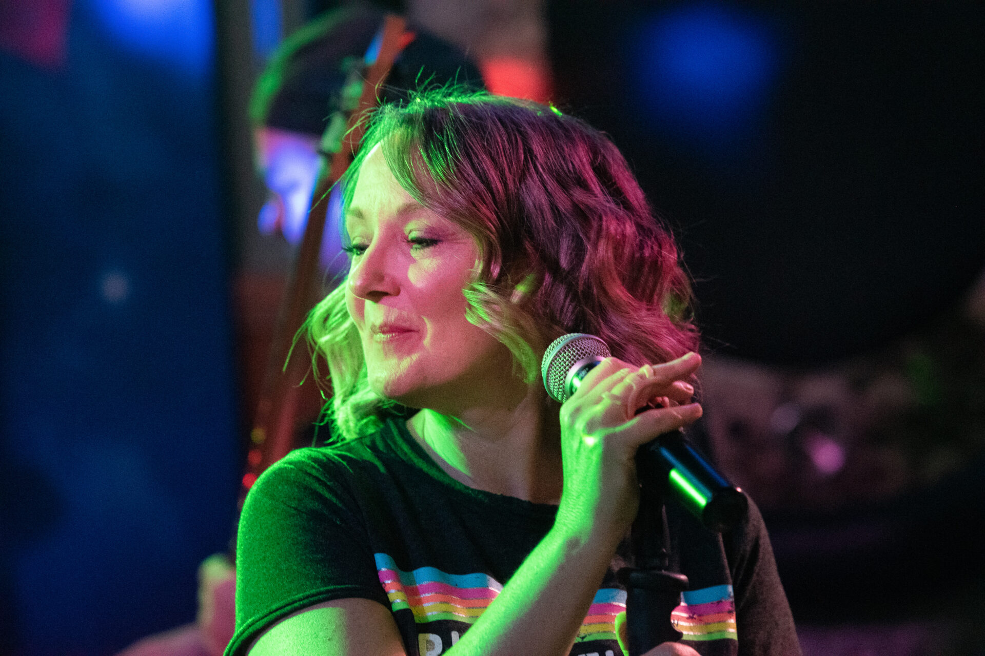 A woman singing into a microphone.