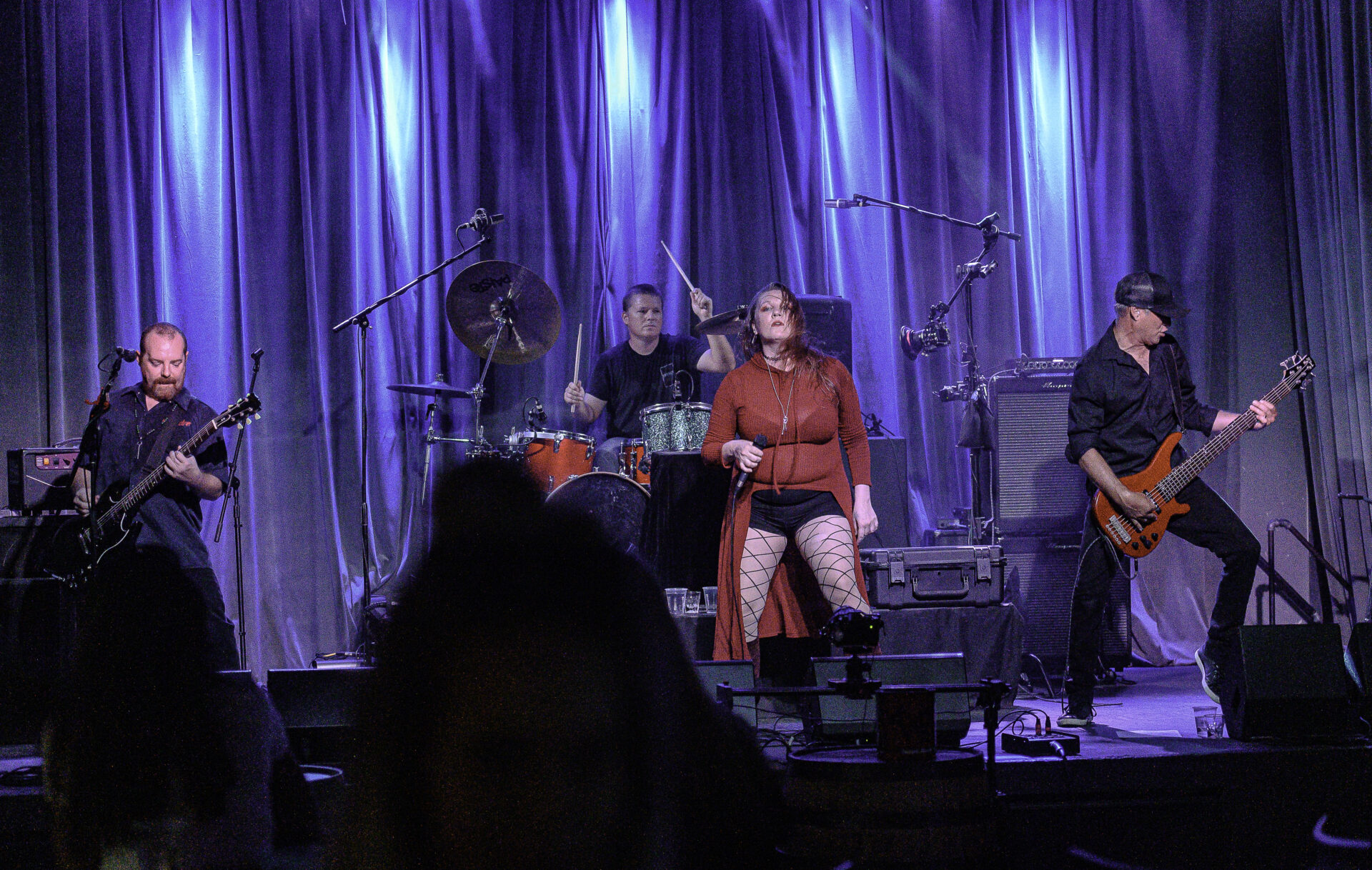 A group of people performs singing on stage.